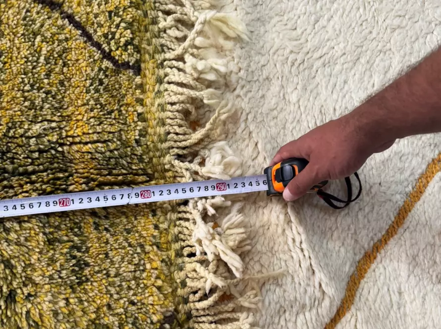 Measuring a handmade wool rug dimension by hand — VOLZAR