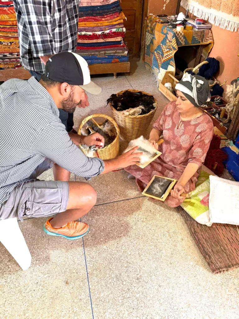 Amazigh artisan hand carding wool, Atlas Mountains, Morocco