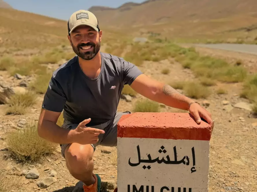 Christophe at Imilchil road sign, Atlas Mountains, Morocco — Volzar sourcing route