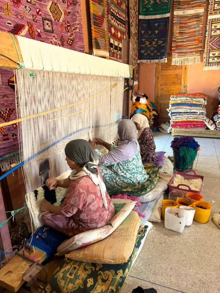 Amazigh women weaving on a traditional loom, Atlas Mountains, Morocco